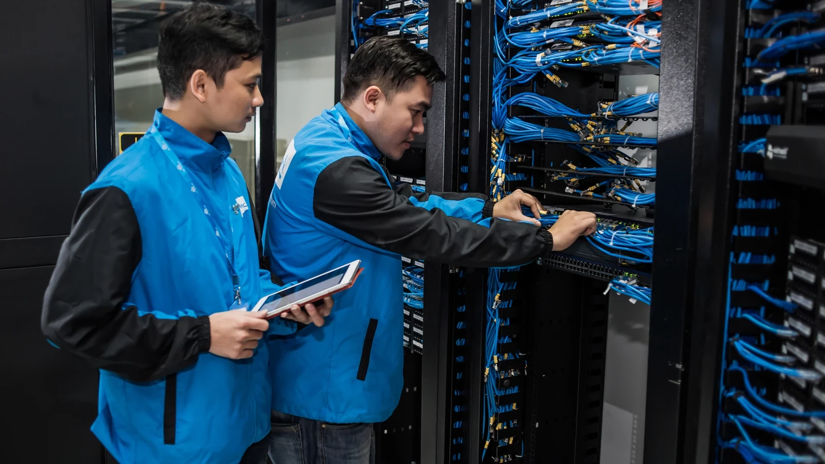 Technicians working inside a commercial data center