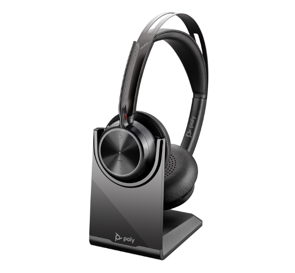 HP product image of Voyager Focus 2 on its optional charging stand, with the microphone boom raised.